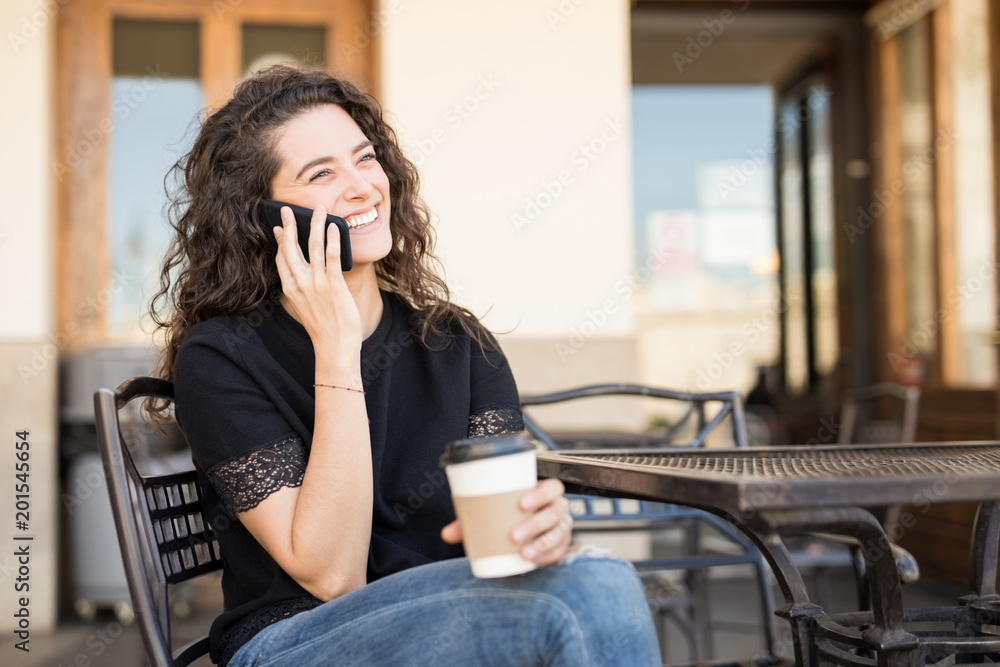 Woman in conversation with a friend on phone Woman in conversation with a friend on phone