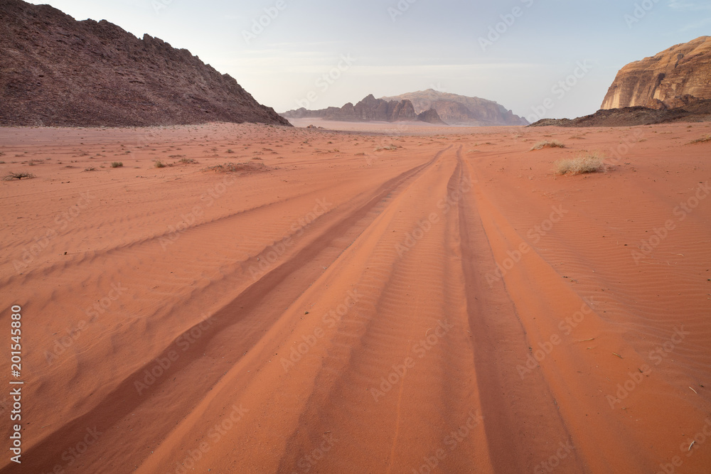 car trails in red sand in desert Wadi Rum in Jordan
