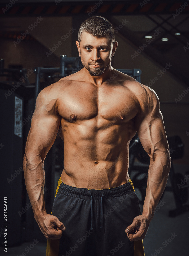 european caucasian athletic man bodybuilder showing his muscular body. man  with big arms looking at camera. Biceps workout clouse-up. bodybuilders  portrait Stock Photo
