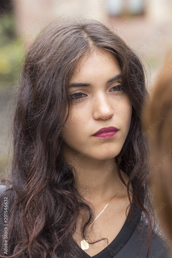 portrait of brunette girl with distracted look portrait of brunette girl with distracted look