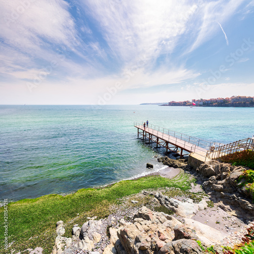 pierce on the seashore in summer. beautiful weather. people in the distance have a photo shoot. Nice travel location of Sozopol, Bulgaria 