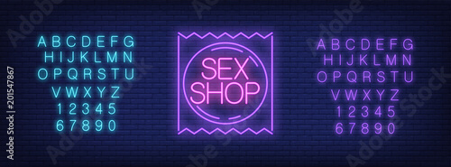 Neon alphabet and Sex Shop emblem over brick background. Erotica, entertainment club, nightlife. Advertisement concept. For signboards, template design, banners