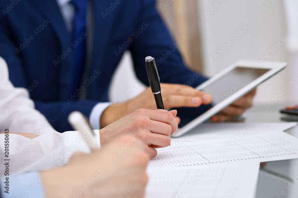 Bookkeepers team or financial inspectors making report, calculating and checking balance. Tax service financial document. Audit or meeting concept Bookkeepers team or financial inspectors making report, calculating and checking balance. Tax service financial document. Audit or meeting concept