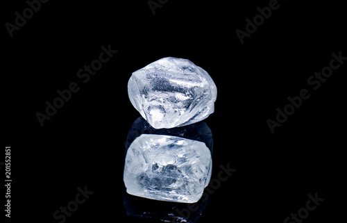 Raw diamond isolated on black background. photo