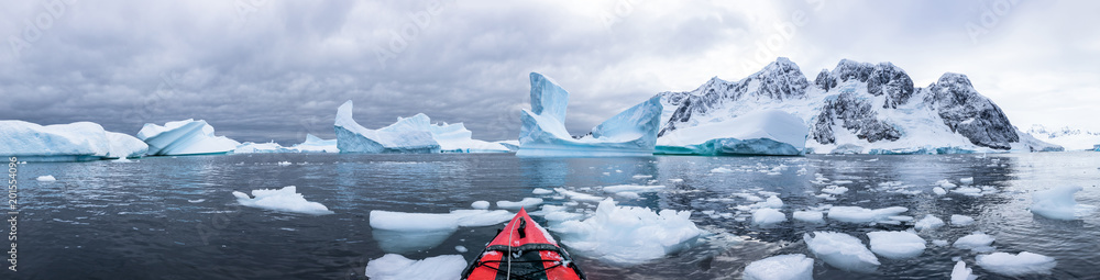 Panoramic view of kayaking in the Iceberg Graveyard in Antarctica