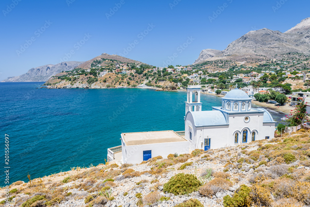 Beautiful white blue greek church monastery Agios Athanasios Timiou Staurou with amazing views to the sea situated in a small greek village Kantouni of Kalymnos Island, Kos Island, Dodecanese, Greece