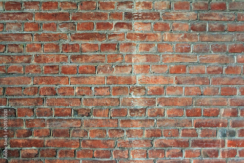 A close-up shot of the old rough brick masonry wall lined with red clumsy brick for creativity, textures and background.