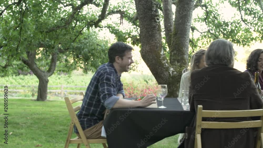 Medium group of people talking and drinking in a winery Medium group of people talking and drinking in a winery