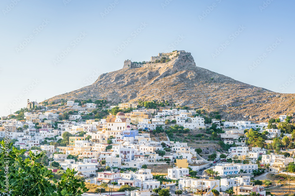 Beautiful sunny village town Panteli harbor view to the greek blue sea water from the old castle with boats cruising surrounded mountains, Medieval Castle, Leros, Dodecanese Islands, Greece 