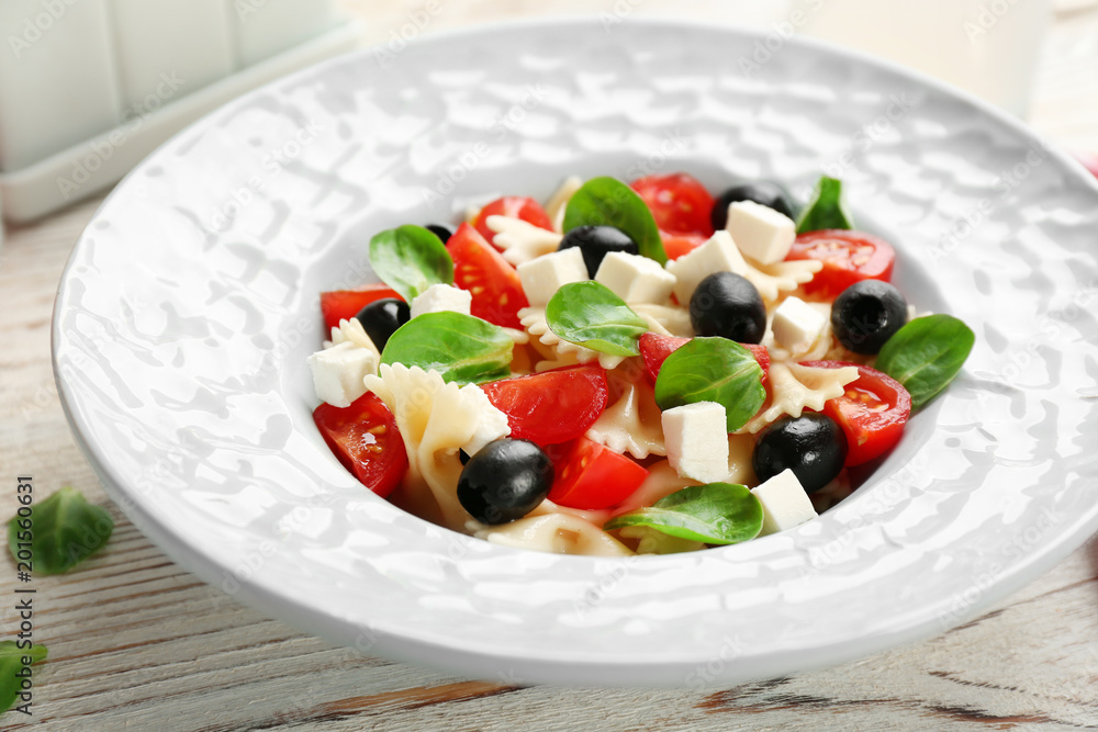 Plate with delicious pasta primavera on table Plate with delicious pasta primavera on table
