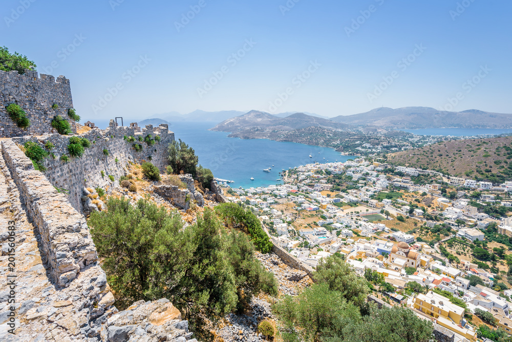 Beautiful sunny village town Panteli harbor view to the greek blue sea water from the old castle with boats cruising surrounded mountains, Medieval Castle, Leros, Dodecanese Islands, Greece 