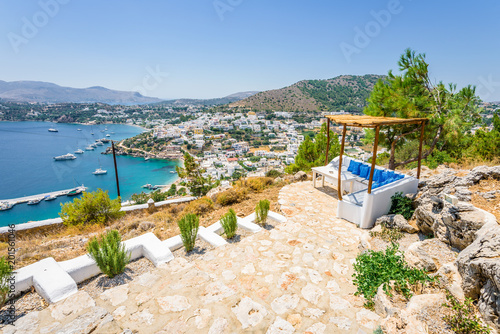 Beautiful sunny village town harbor view to the greek blue sea with clear water with boats cruising surrounded by hills mountains, Panteli, The View, Leros, Dodecanese Islands/ Greece – July 21 2017