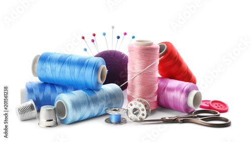 Tableau sur toile Color threads and sewing accessories on white background
