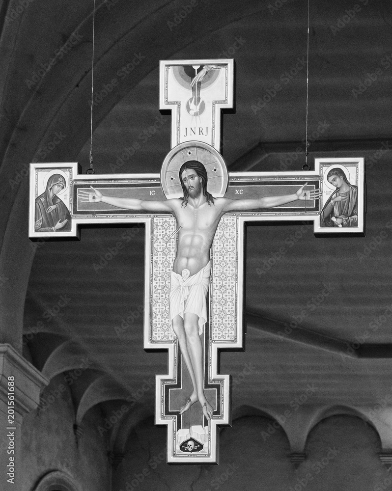 Modern wooden crucifix hanging in the central nave of the Abbey of Carceri, Italy.