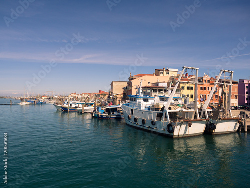 Fishing boats moored in a canal in Chioggia, Italy. © isaac74