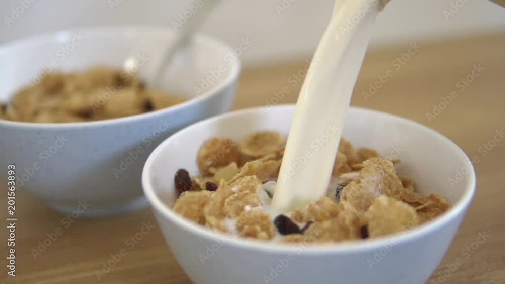 Сloseup healthy breakfast: pour flakes of milk Сloseup healthy breakfast: pour flakes of milk