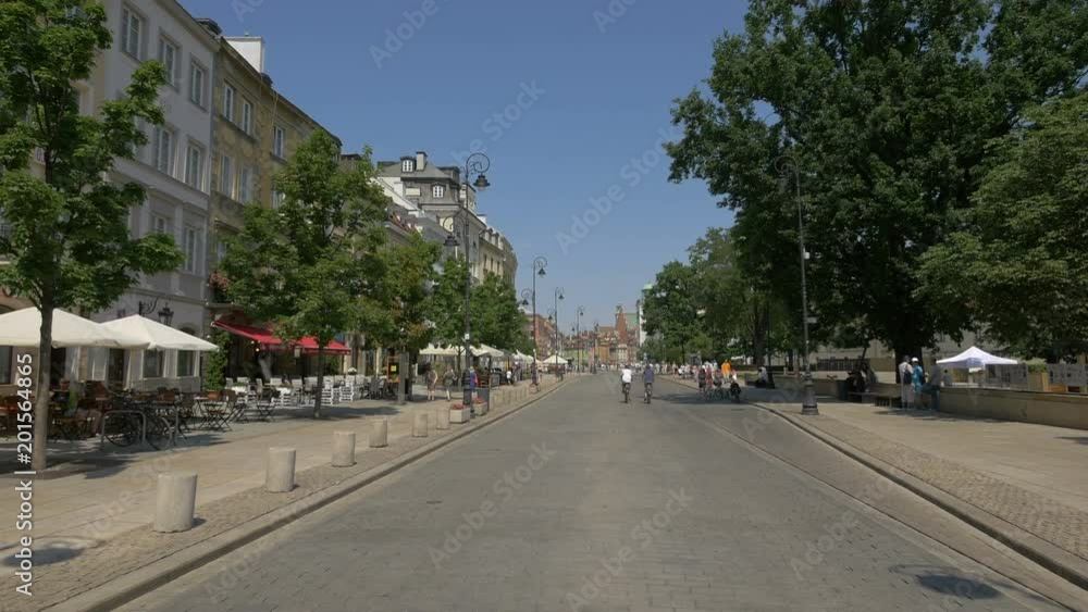 Two men riding bikes on Krakowskie Przedmiescie street Two men riding bikes on Krakowskie Przedmiescie street