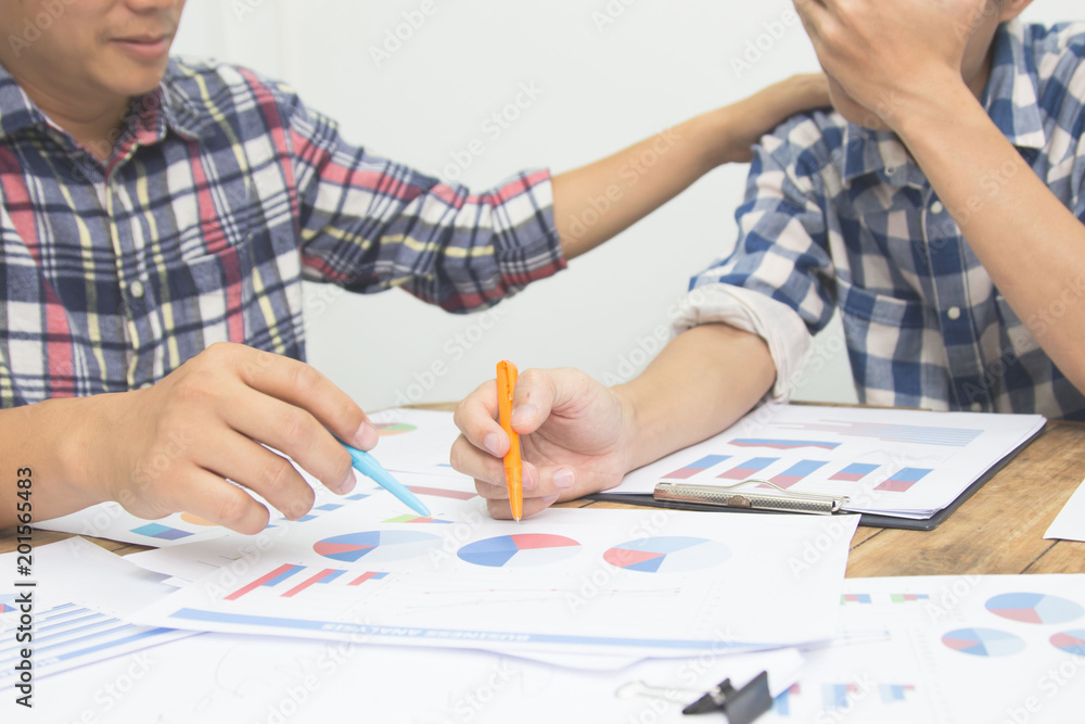 Business team financial plan and analyzing investment charts in office. Business team financial plan and analyzing investment charts in office.