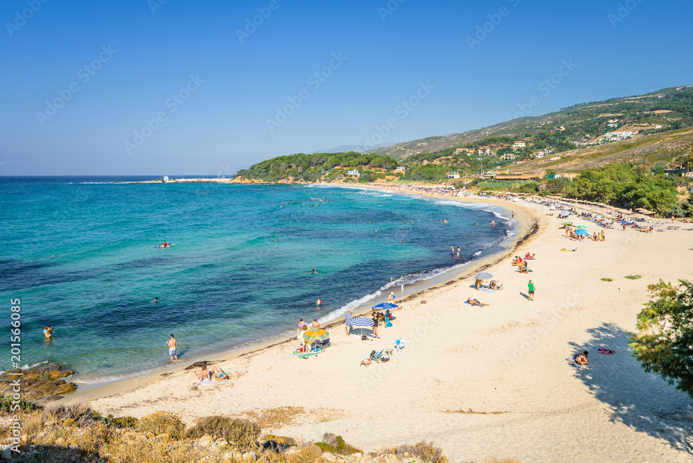 Sunny beautiful summer beach coast view to the greek blue sea white pure sand perfect for holiday relaxing swimming playing , Ikaria Island, Livadhi Beach, Messakti Beach, Armenistis , Sporades,Greece