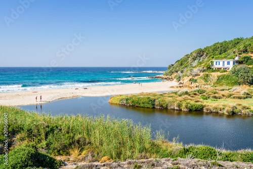 Sunny beautiful summer beach coast view to the greek blue sea white pure sand perfect for holiday relaxing swimming playing   Ikaria Island  Livadhi Beach  Messakti Beach  Armenistis   Sporades Greece