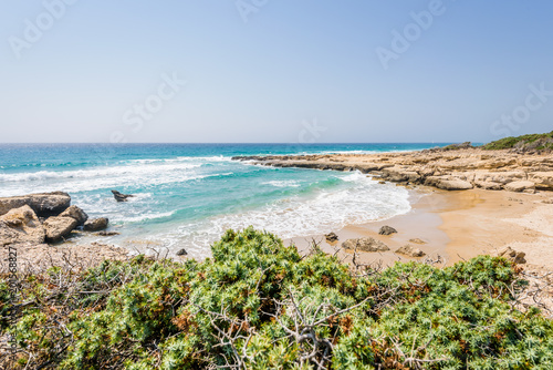 Fototapeta Naklejka Na Ścianę i Meble -  Beautiful sunny coast view to greek beach mediterranean blue sea with crystal clear water and pure white sand empty place with some mountains rocks, Theologos, Kefalos, Kos, Dodecanese Islands, Greece