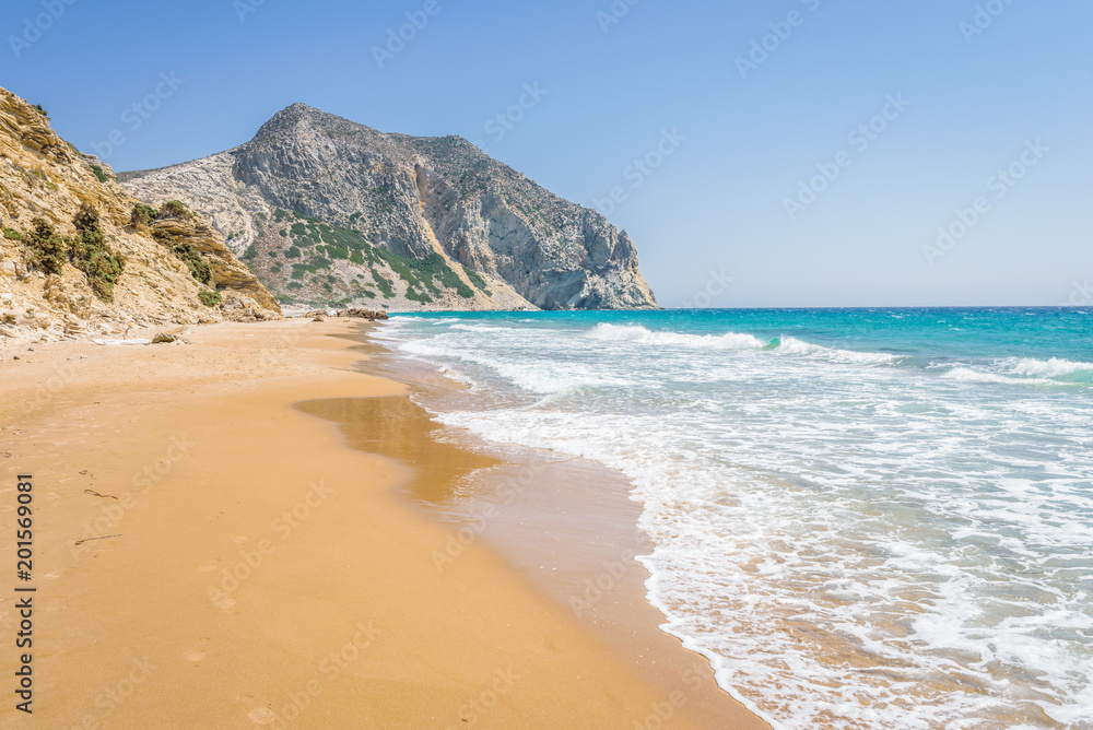 Beautiful sunny coast view to the greek mediterranean blue sea with crystal clear water and pure sandy beach empty place with some mountains rocks surrounded, Kos, Dodecanese Islands, Greece