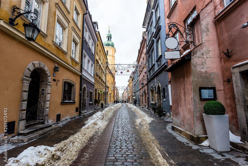 Snowy alley in downtown Warsaw during january, mid winter, christmas decorations are still up