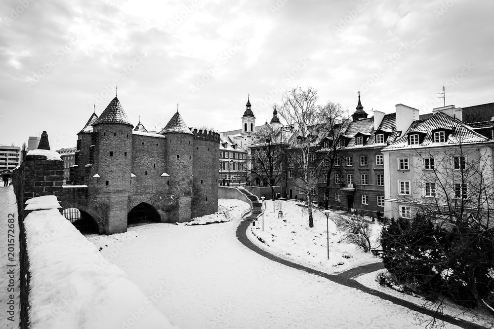 Warsaw Barbacan fortress castle in winter is in the capital city of Poland. Old town is the historic center of Warsaw. Sights of Poland. Snow day.architecture concept., black and white
