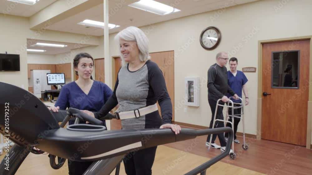 Medium shot of a senior woman walking on a rehabilitation treadmill Medium shot of a senior woman walking on a rehabilitation treadmill
