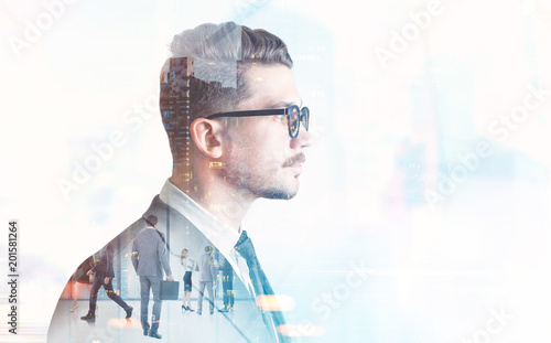 Businessman in glasses, blurred city