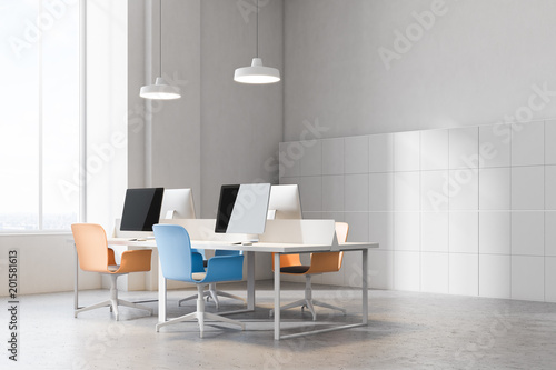 Corner of orange and blue chairs office © ImageFlow