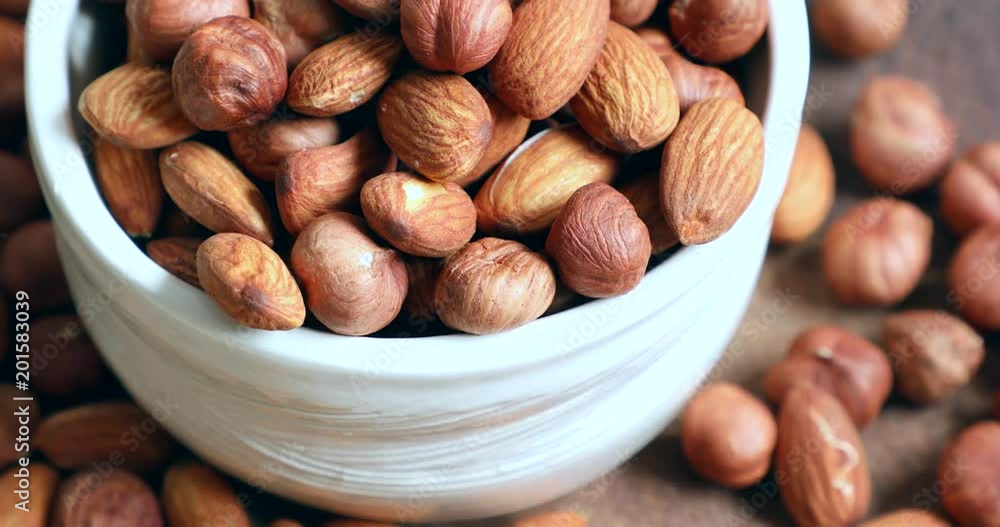 Nuts close-up. Heap almonds and hazelnuts Nuts close-up. Heap almonds and hazelnuts