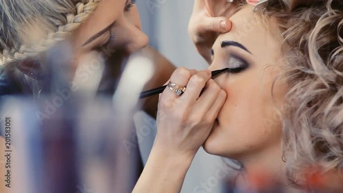 makeup artist makes models eye makeup