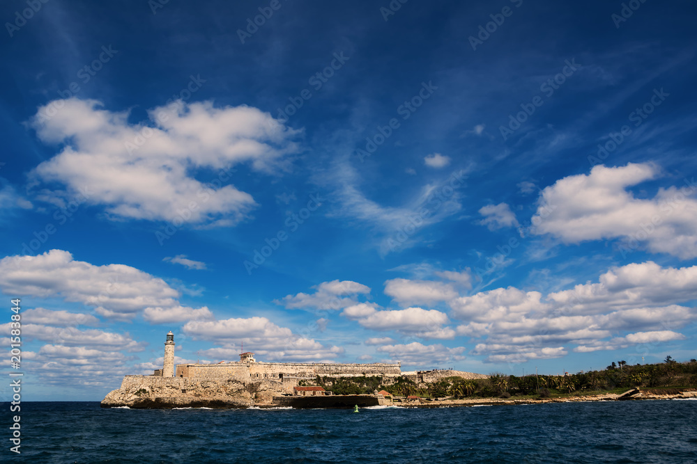 Morro Castle of Havana and its lighthouse with clouds in blue sky