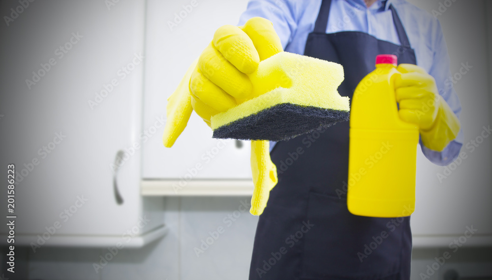 man with scourer and cleaning products cleaning the house man with scourer and cleaning products cleaning the house