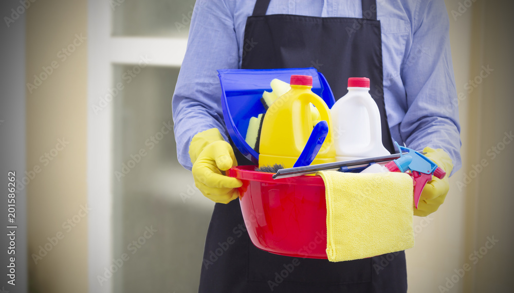 man with bucket and cleaning products in the house man with bucket and cleaning products in the house