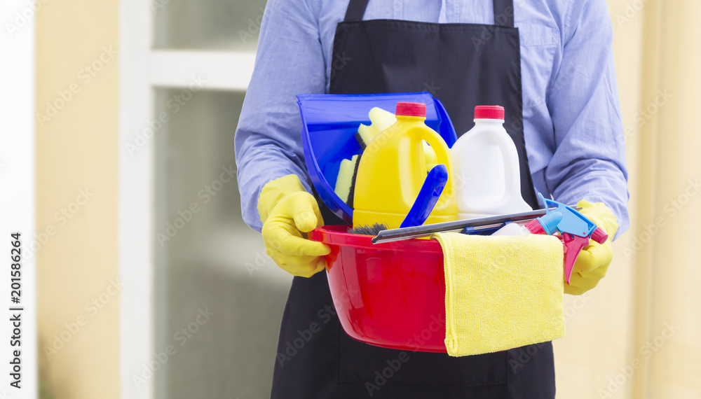 man with bucket and cleaning products in the house man with bucket and cleaning products in the house
