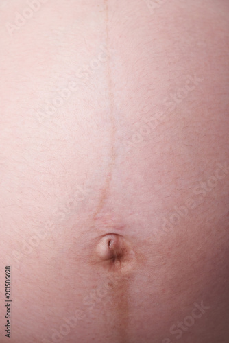 Close-up of belly button pregnant woman
