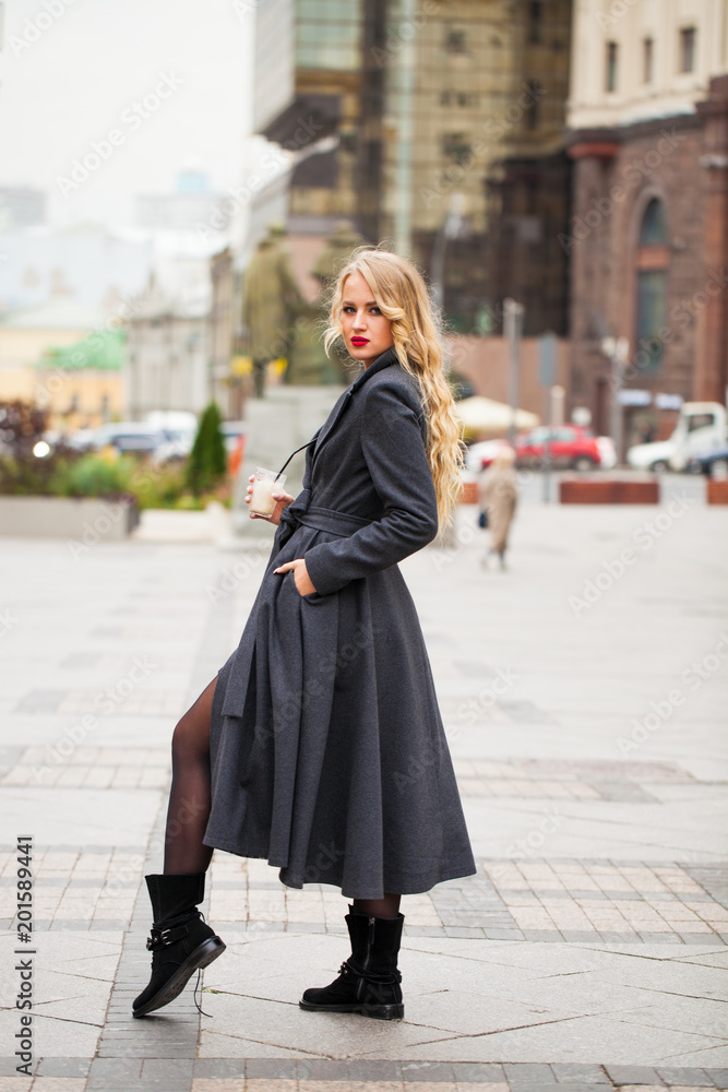 Fototapeta premium Portrait of a young beautiful woman in gray coat
