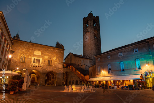 old square with fountain and tower in bergamo