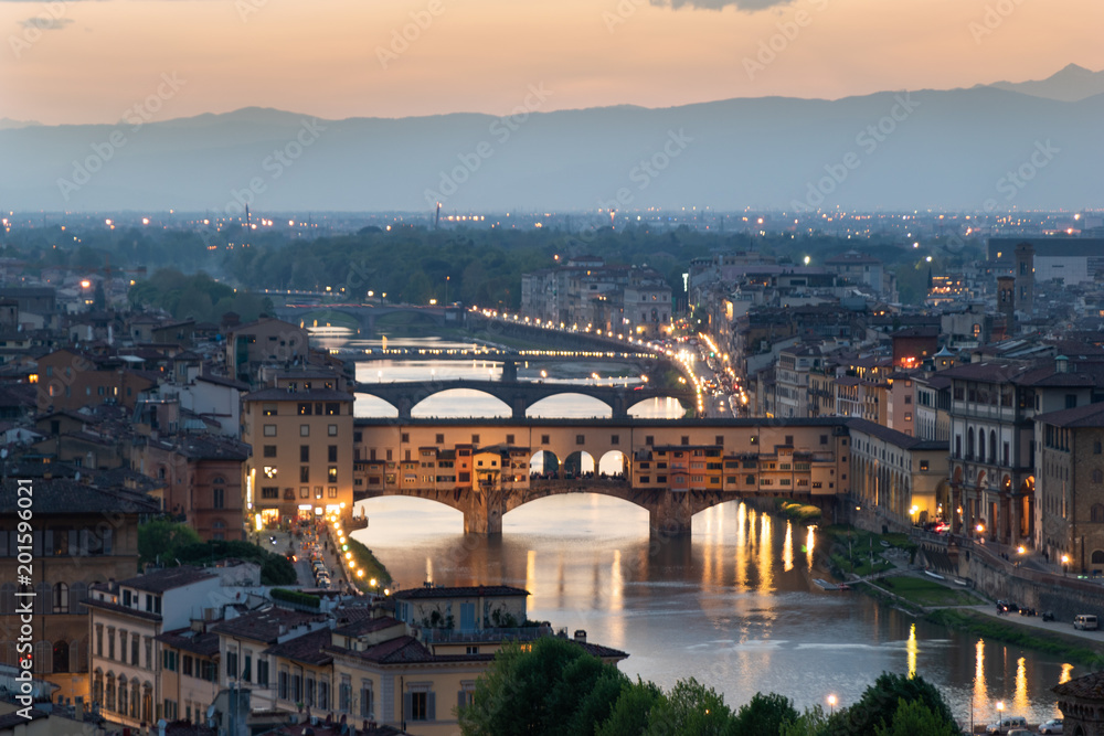 Florence cityscape with Arno river and Ponte vecchio at sunset - Tuscany, Italy 