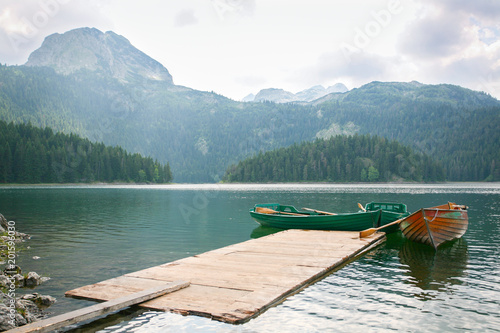 Boats on the turquoise waters of the Black Lake  Montenegro