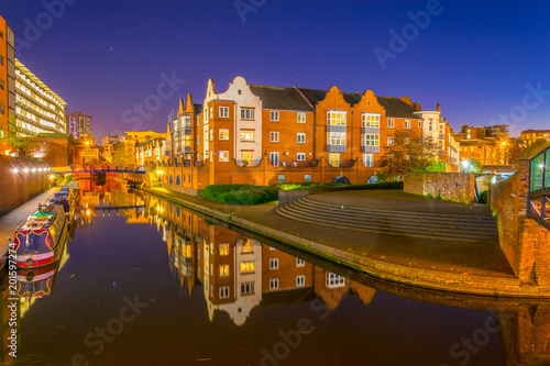 Night view of brick buildings alongside a water channel in the central Birmingham, England photo