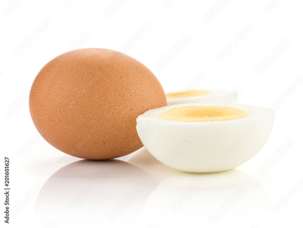 One brown chicken egg with two boiled sliced halves isolated on white background. One brown chicken egg with two boiled sliced halves isolated on white background.