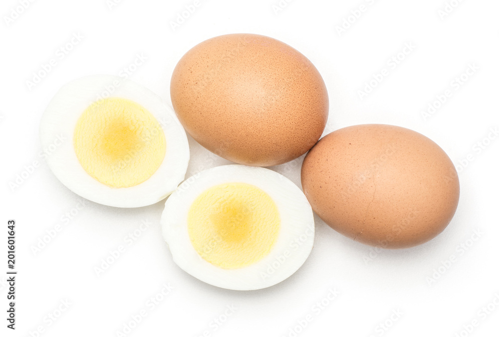 Two brown chicken eggs with boiled sliced halves top view isolated on white background. Two brown chicken eggs with boiled sliced halves top view isolated on white background.