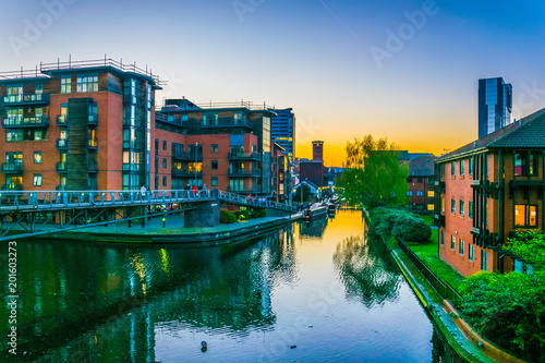 Sunset view of brick buildings alongside a water channel in the central Birmingham, England photo