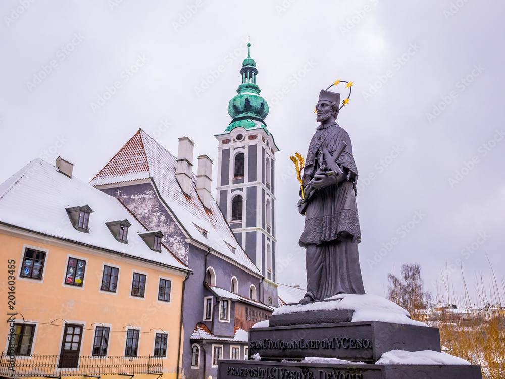 Fototapeta premium Historical houses and castle landmark statue river winter season snow in Cesky Krumlov. Czech Republic
