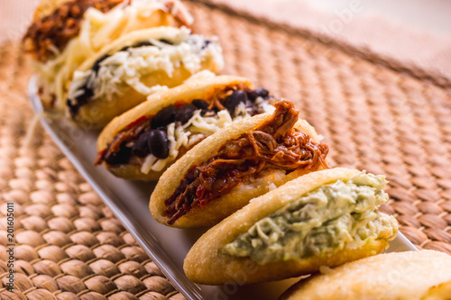 Different types of arepas, meat, black beans, cheese, fried plantain, typical South American food