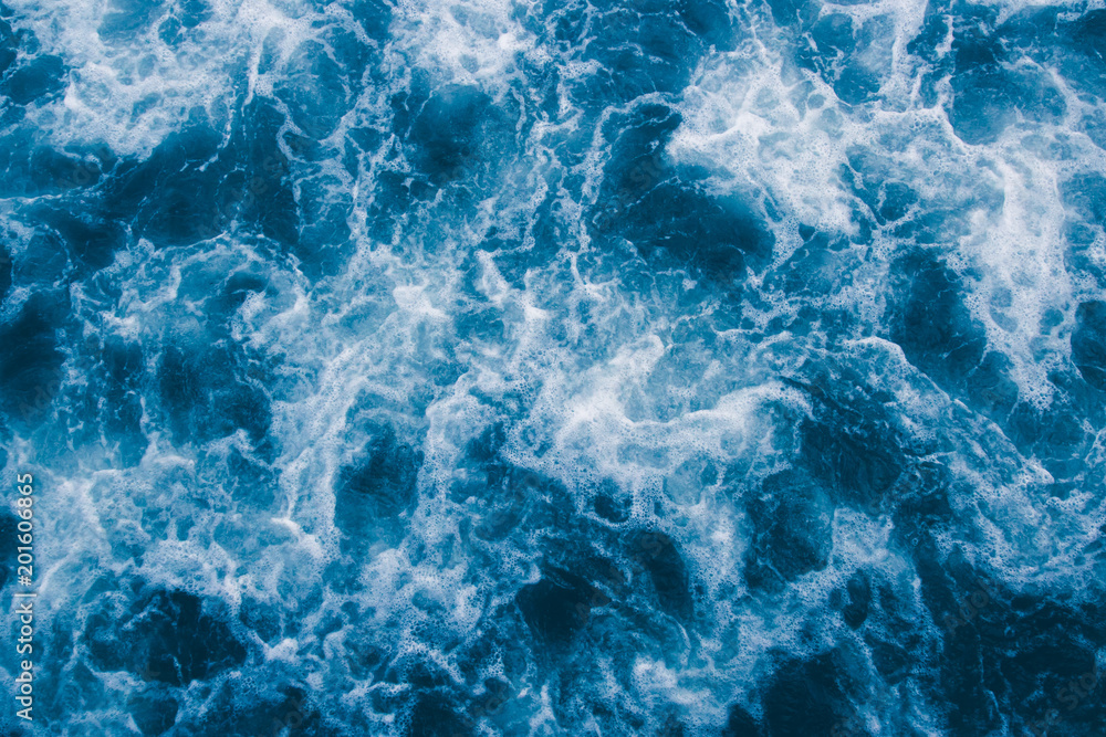 Abstract blue sea waves with white foam for background, natural summer background, pattern concept Abstract blue sea waves with white foam for background, natural summer background, pattern concept