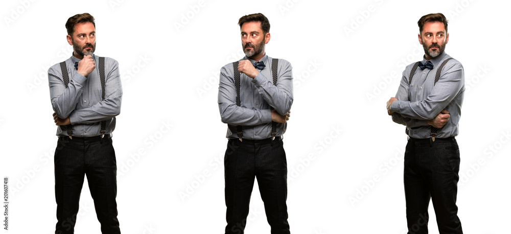 Middle age man, with beard and bow tie doubt expression, confuse and wonder concept, uncertain future Middle age man, with beard and bow tie doubt expression, confuse and wonder concept, uncertain future
